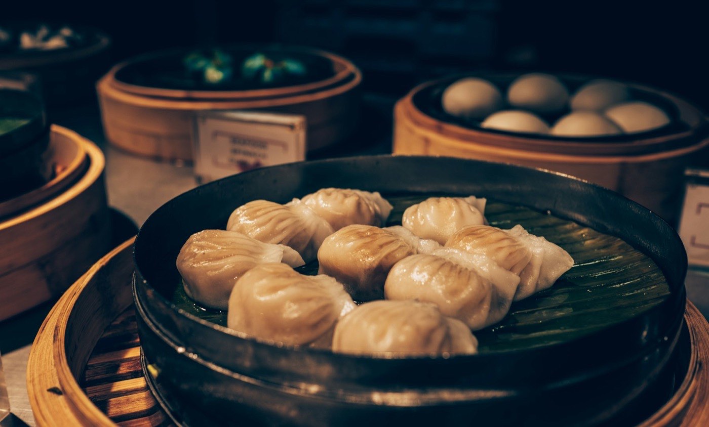 Steamed buns and dumplings in bamboo steamer baskets
