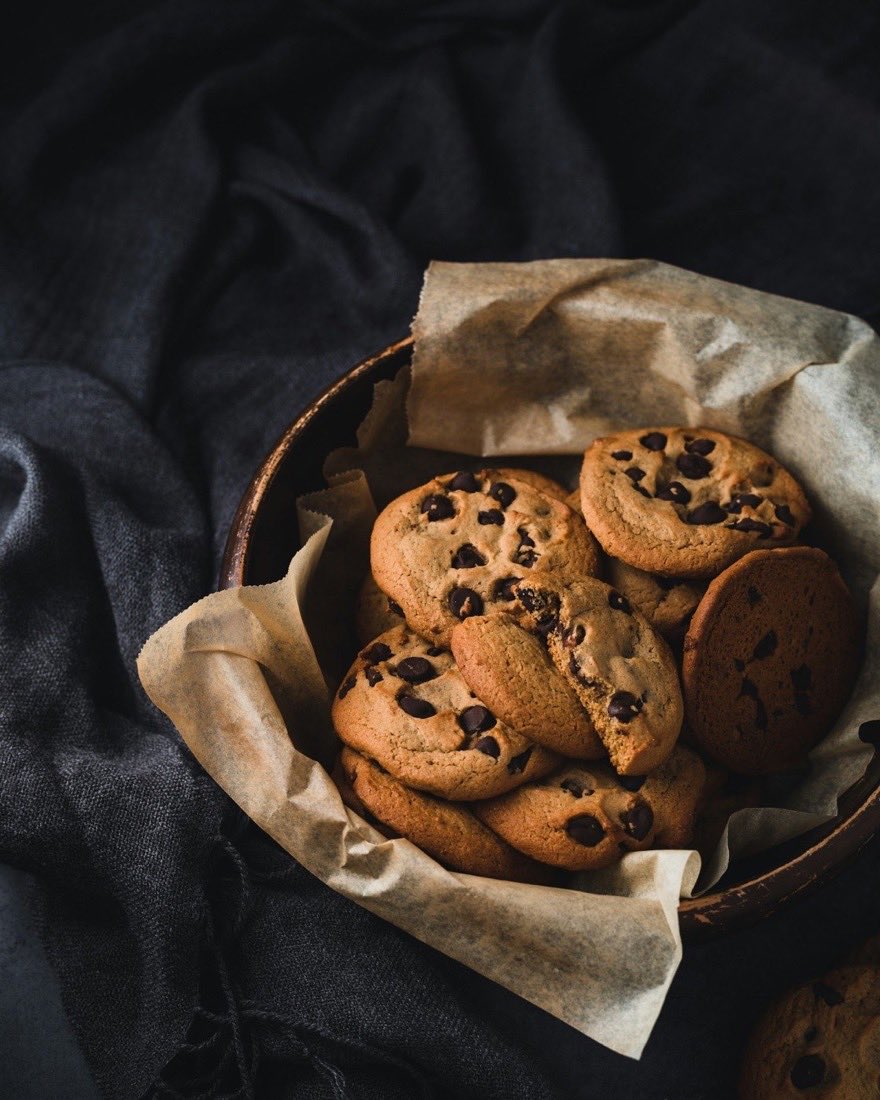 Chocolate chip cookies in a bowl lined with baking paper